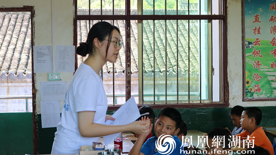 （图为志愿者为小朋友讲解诗歌的意义 康博英 摄）